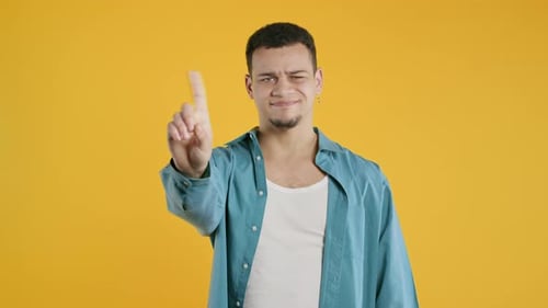 Man Wags Finger in 'No' Gesture