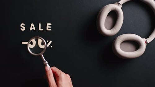 Magnifying Glass Finds Headphones on Fifty Percent Sale