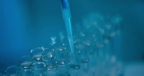 Close up of Pipette Adding Liquid to Test Tubes