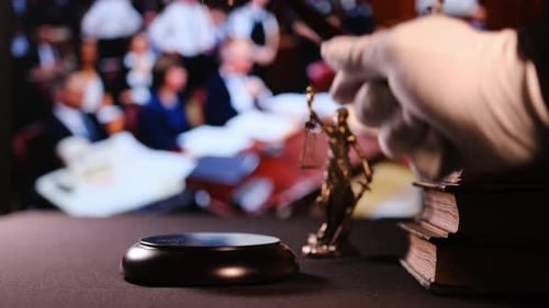 Gavel Striking Sounding Block in Courtroom Setting