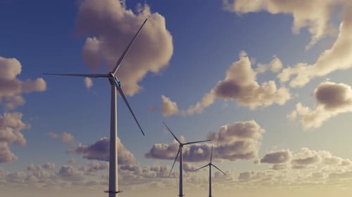 Large wind turbines generating electricity against the backdrop of a beautiful sunset and clouds.