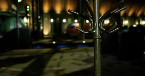 Elegant Coat Rack Stands in a Dimly Lit Venue with Warm Lighting Effects