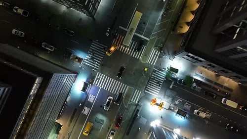 Aerial view rotating above traffic on the illuminated streets of Midtown, New York