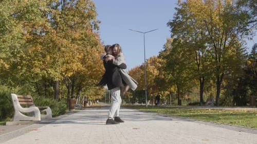 Romantic Couple Hugging in a Vibrant Fall Park Setting