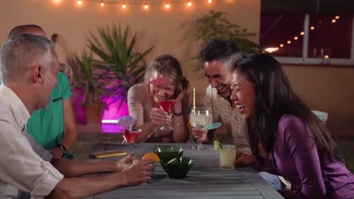 Friends Celebrate with Cocktails at Night