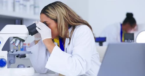 Science, stress and microscope with a doctor woman at work in a laboratory for research