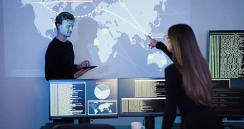 Professionals Reviewing Data Analytics on a Projected World Map