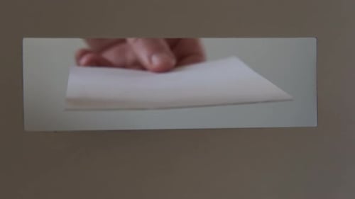 Close Up Shot of Person Casts Her Ballot During Voting for Elections at a Polling Station