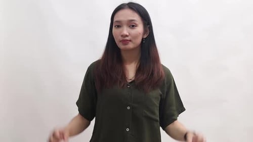 Smiling Young Woman Making OK Hand Gestures
