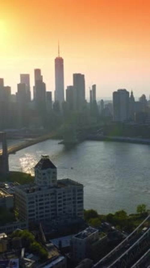 Manhattan and Brooklyn Bridges over East River at Golden hour.