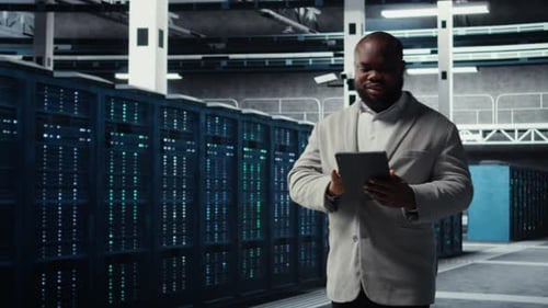 Server Farm Employee Upgrading Gear for Increased Processing