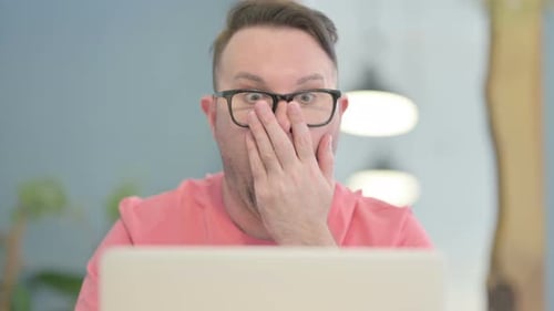 Close Up of Man Reacting to Loss on Laptop