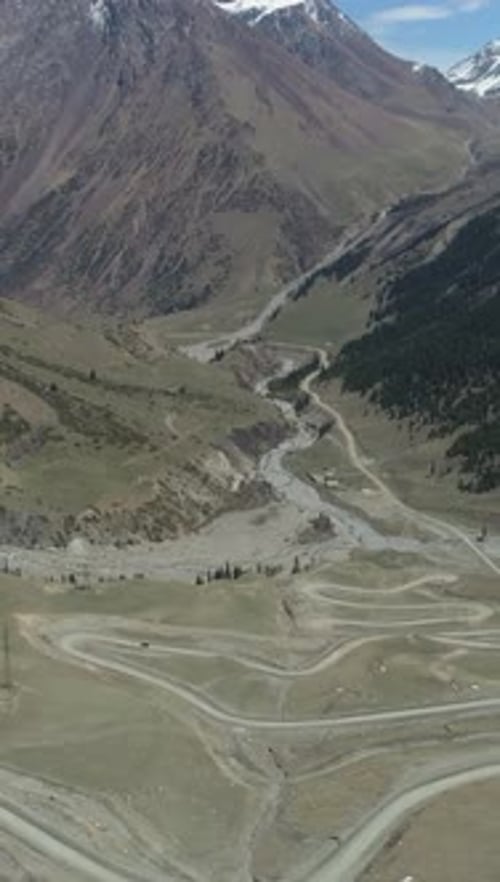 Curvy Serpentine Road Pass in High Mountains Vertical Video
