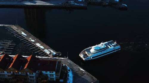 Drone shot around a transport ferry docking in Slemmestad, winter day in Norway