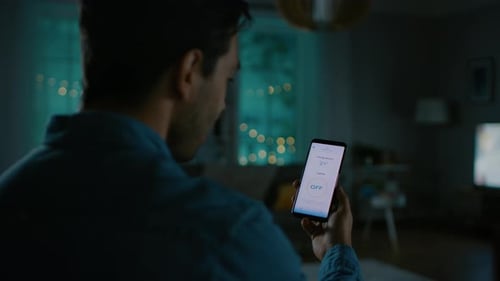 Man controls home lights using his smart phone