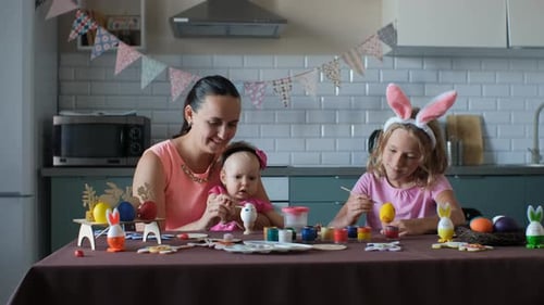 Family Together Painting Easter Eggs at Home