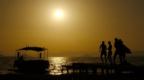 Silhouettes of One Boat Moored By Pier
