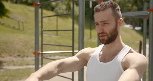 Man Stretching Arms in Outdoor Park Workout