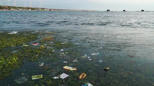 Garbages Floating In Dirty Sea Water. Polluted Beach In Son Hai, Vietnam. static, slow motion