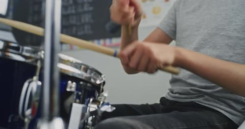 Close Up Shot of Primary School Boy Practicing Drums in Music Class Dreaming to Become Drummer