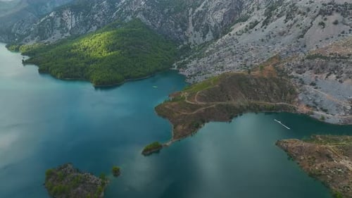 Aerial View Paddleboarding Adventure Through a Green Canyon With Stunning Scenery