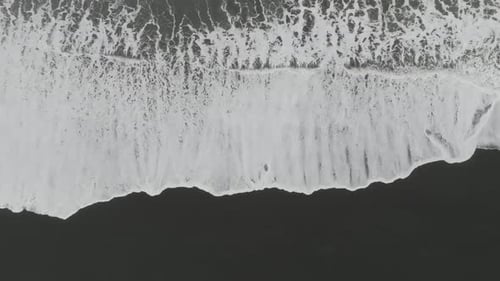 Aerial view of black sand beach in Iceland in winter.