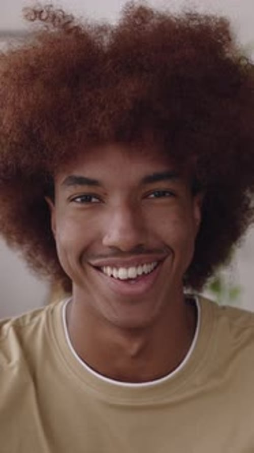 POV or Front Portrait of Happy Millennial Latin American Guy Smiling at Camera