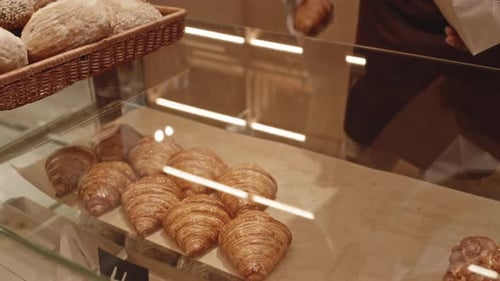 Bakery Salesman Selling Croissants to Customer