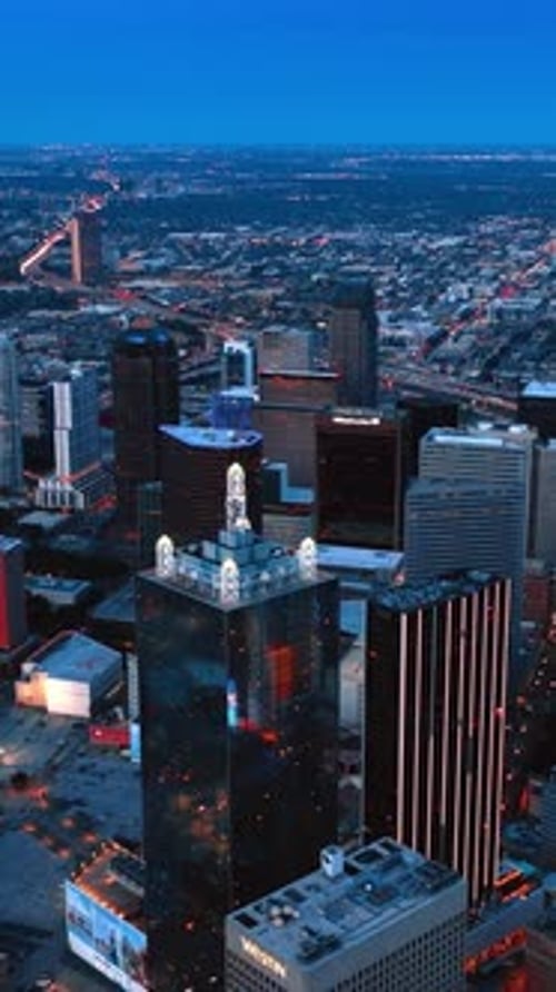 Lowering above the downtown of stunning Dallas, Texas, USA at dusk.