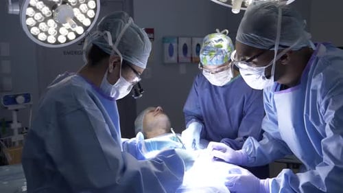 Surgeons Perform Operation in Operating Room with Patient