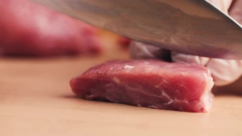 Slicing Raw Meat on a Cutting Board
