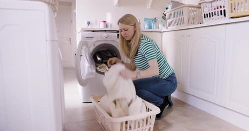 Housewife, laundry and washing machine for clothes in basket, cleaning and chores for the day