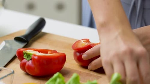 Red Pepper Being Prepared on Wooden Cutting Board