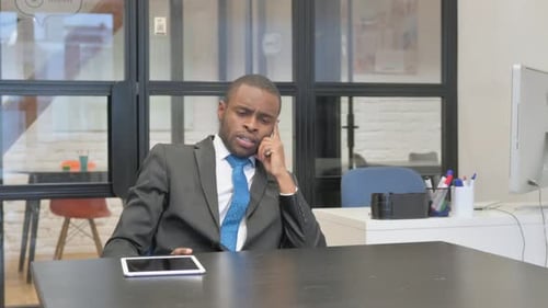 Man in Suit at Desk Having Idea