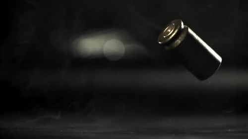 Bullet Casing Spinning in Dark Studio with Smoke