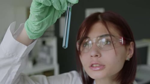 Close-up of Scientist Looking at Results of her Chemical Experiment in Lab