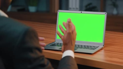 Closeup View From Back Busy Businessman Looking at Green Screen Laptop Talking on Video Call