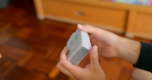 Man removing label from bottle in home interior