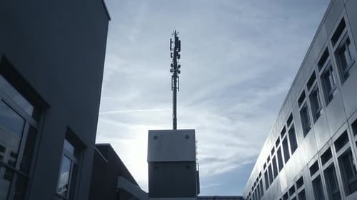 A Tall Urban Cell Tower Stands Out Against a Cloudy Sky Highlighting Its Role in Communications