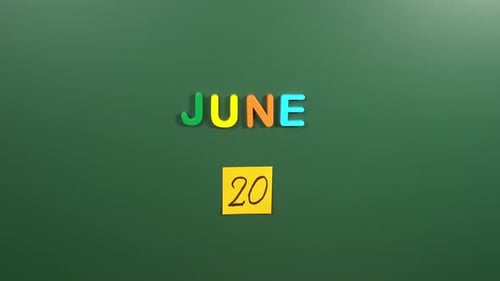 Hand sticking a sticker 20 June calendar day on school board. 20 date of June. Twentieth day