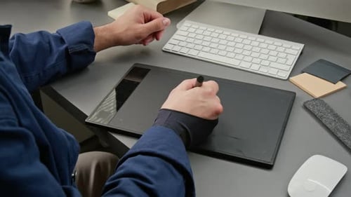 Man Using a Drawing Tablet for UI Design