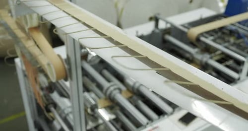 Conveyor on Which Paper Bags are Made Concept of Production Conveyor