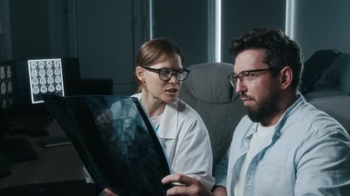 Doctors Reviewing X-ray in Hospital Examination Room