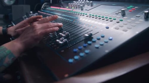 Sound Engineer Working at Studio Mixing Board