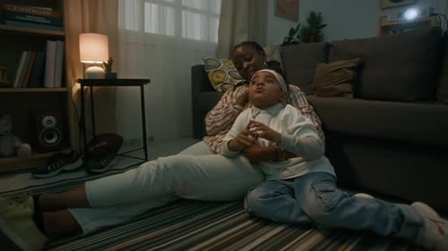 Mother and Child Enjoying Movie at Home Together