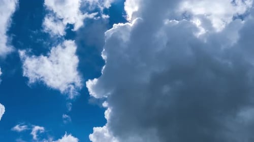 Aerial view of beautiful sky with clouds and sun on a summer day.