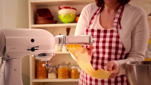 Woman Making Pasta Dough with Pasta Machine