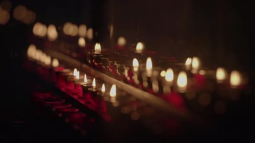 Illuminated Candles in Dark Setting