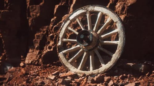 Old Wooden Cart Wheel on Stone Rocks