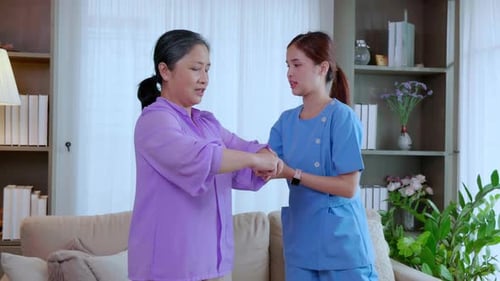 Senior Woman Doing Arm Exercises with Healthcare Provider